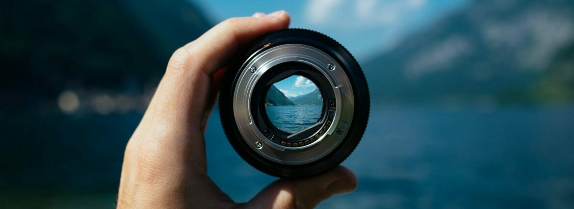 Photo by Paul Skorupskas person holding camera lens