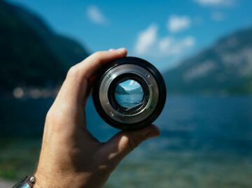 Photo by Paul Skorupskas person holding camera lens