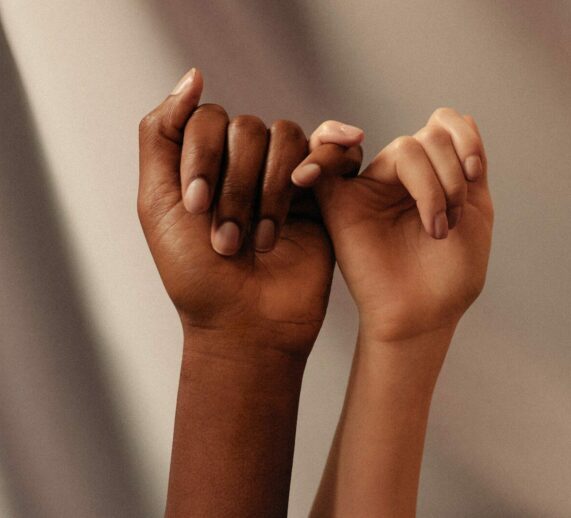 Photo by Womanizer Toys two hands with linked pinky fingers