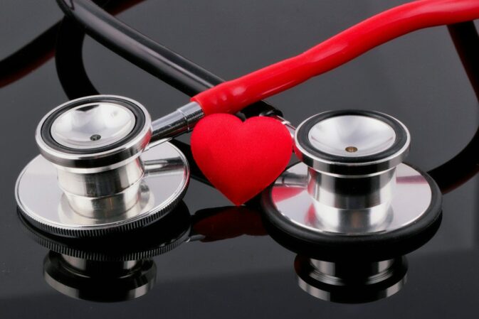 Photo by Marek Studzinski a stethoscope and a heart on a table