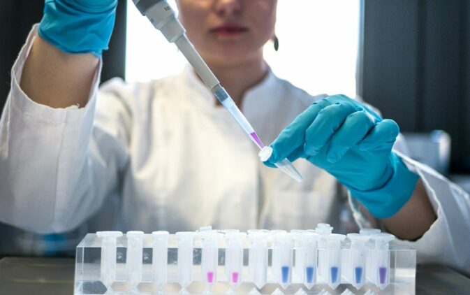 Photo by Julia Koblitz scientist using pipette with test tubes in lab